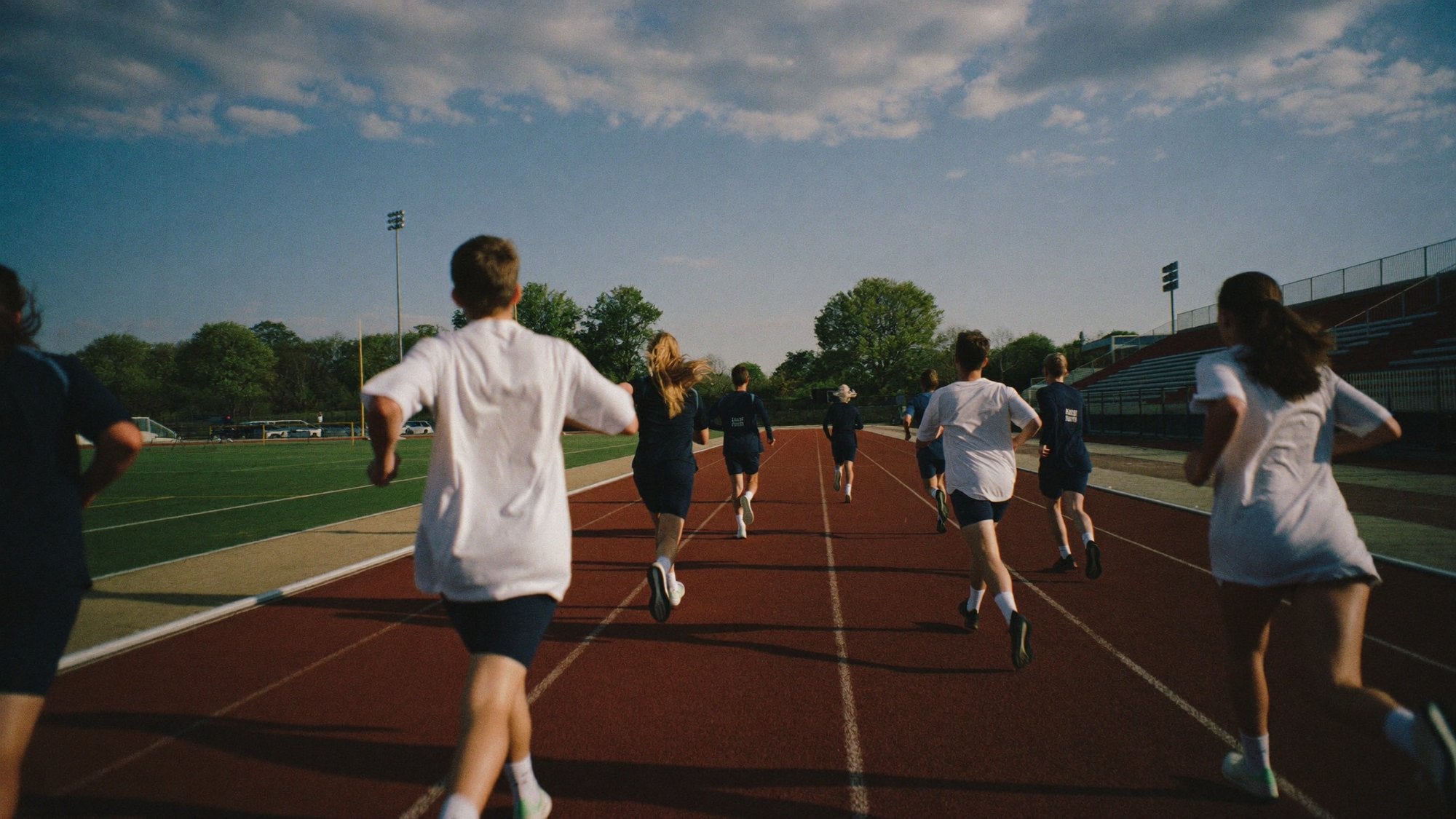 Teen athletes running on an outdoor track